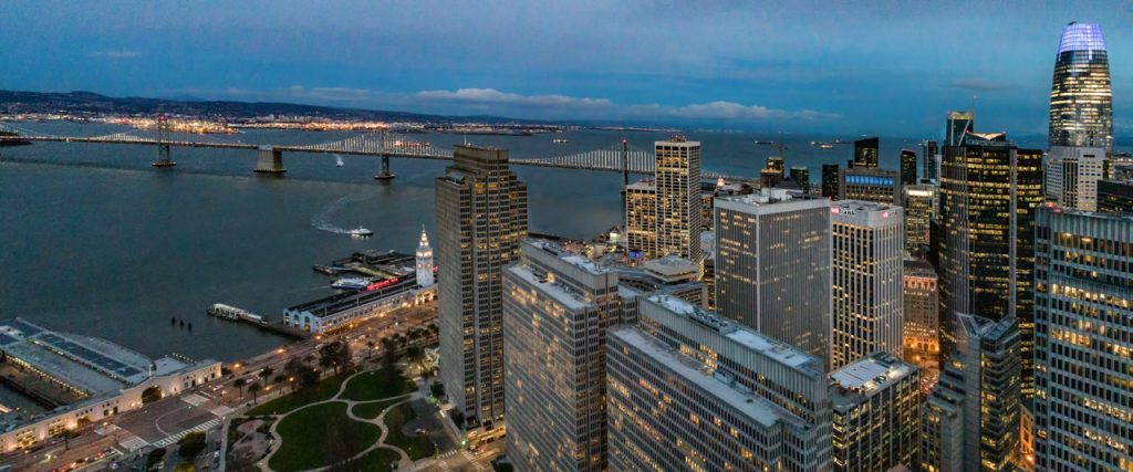 Twilight of downtown San Francisco with bay bridge shot with UAV.